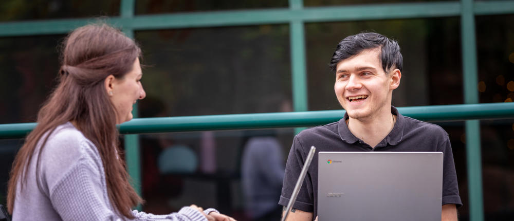 Students Smiling With Laptops