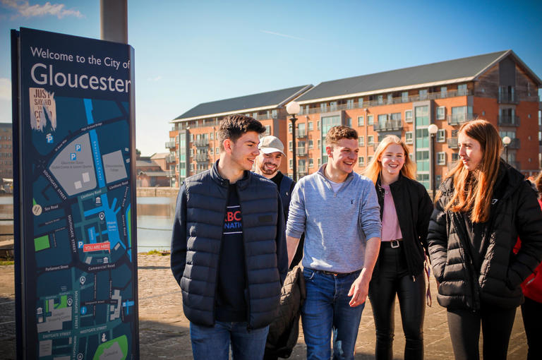 Group of students walking around Gloucester Docks