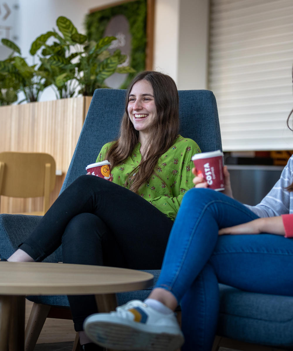 Two international students sat in Graze restaurant enjoying a hot drink