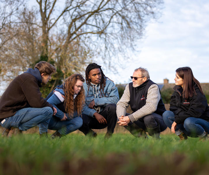 Students And Lecturer Checking Crop Health