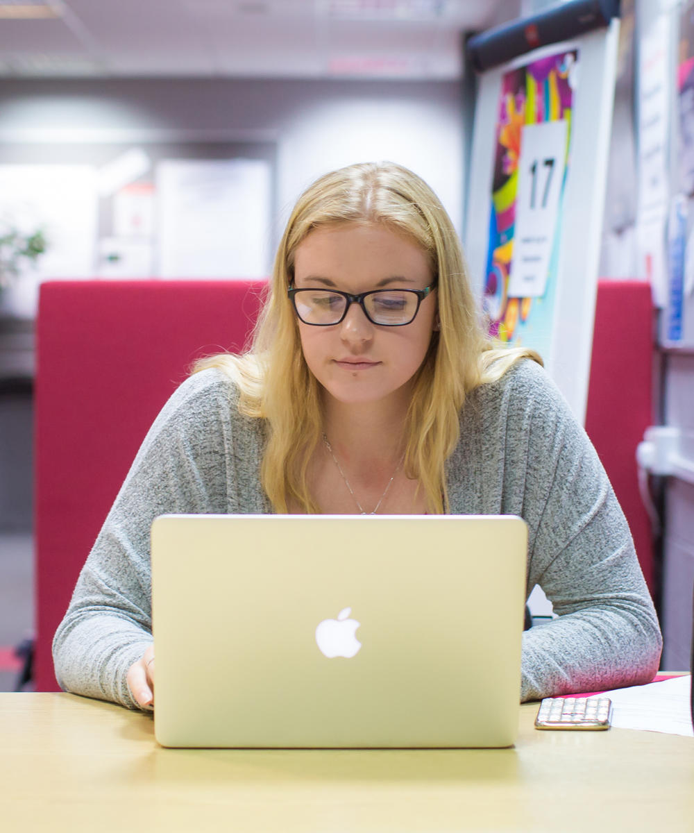 Student On Laptop In Library
