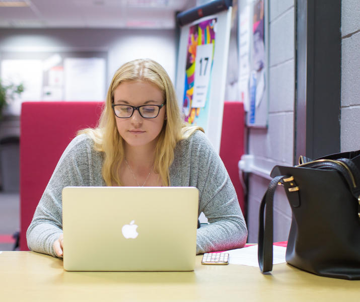 Student On Laptop In Library