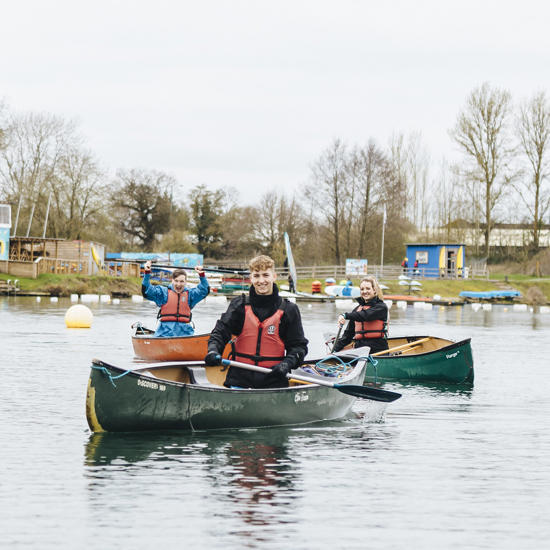 Image of students in boats on the lake rowing