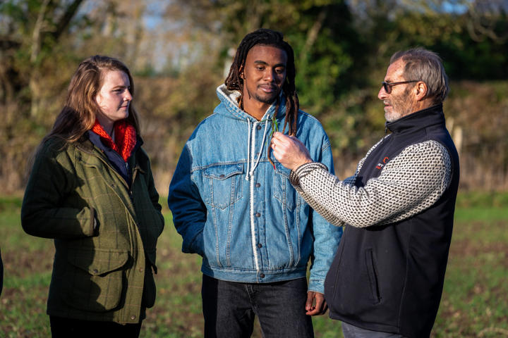 Male And Female Student And Lecturer Checking Crop Health
