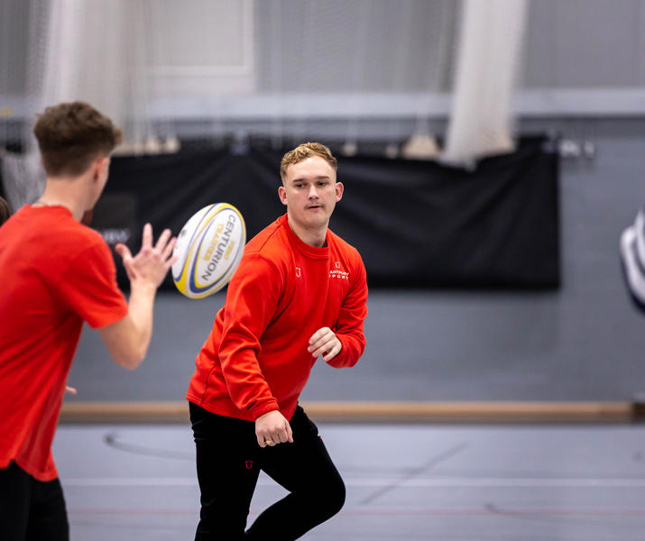 Two students taking part in sports coaching session