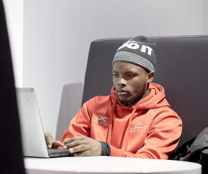 Student Sat At Laptop In College Learning Centre