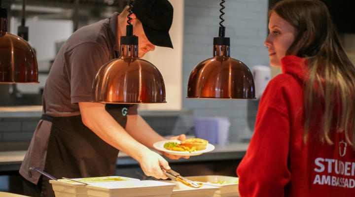 Student being served food in Graze