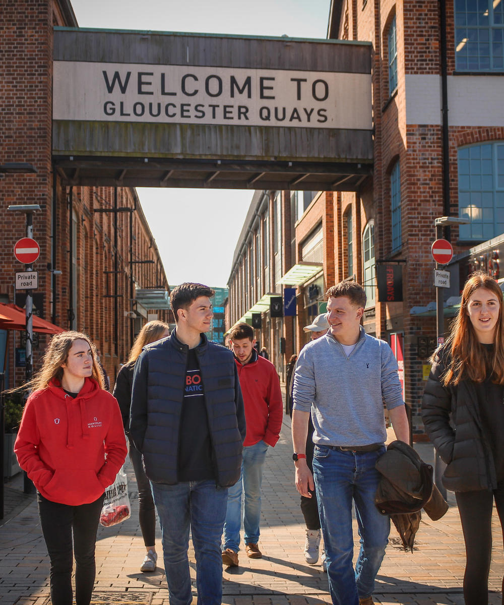 Group of students walking through Gloucester Quays