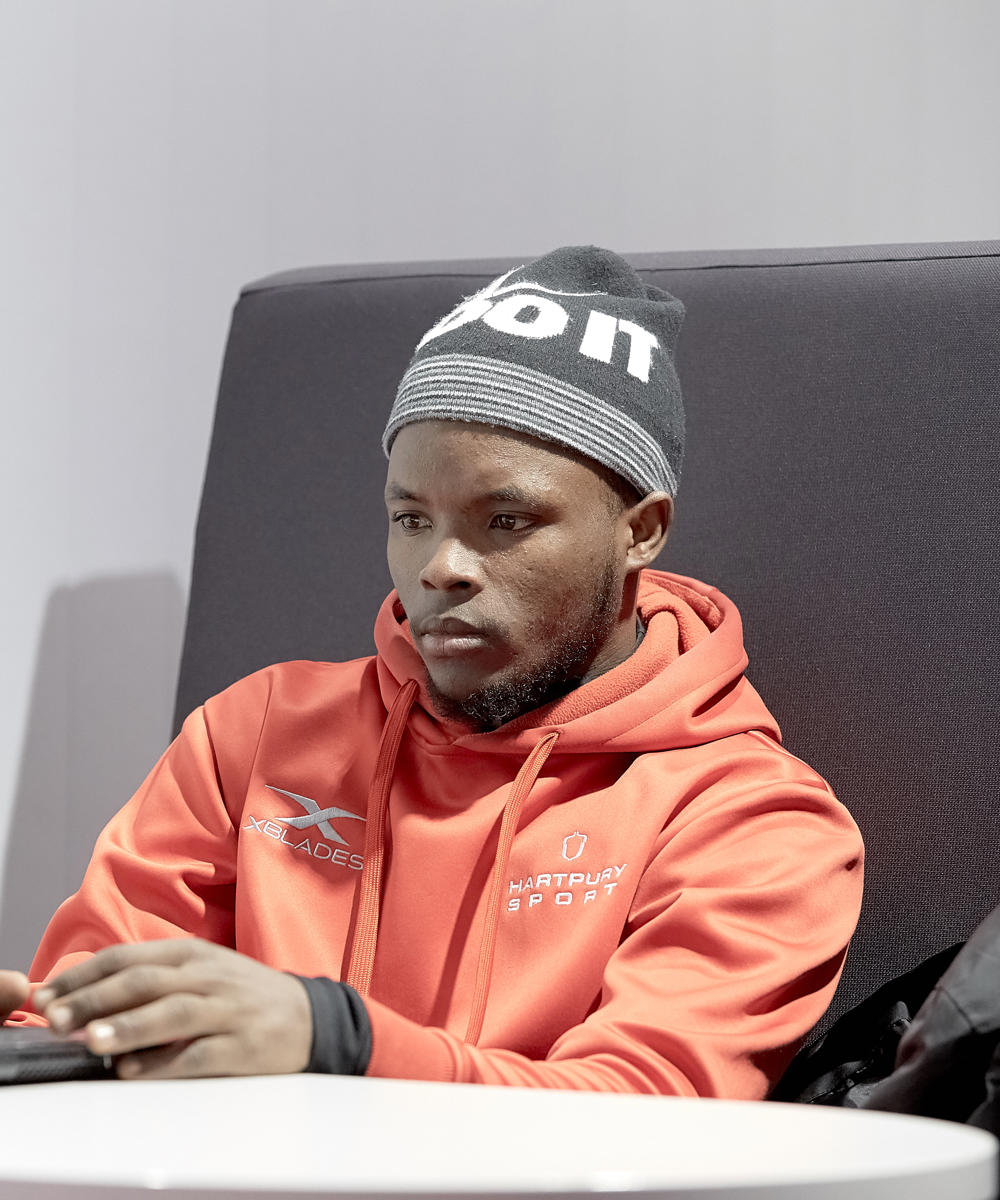 Image of international student working on their laptop in a study booth